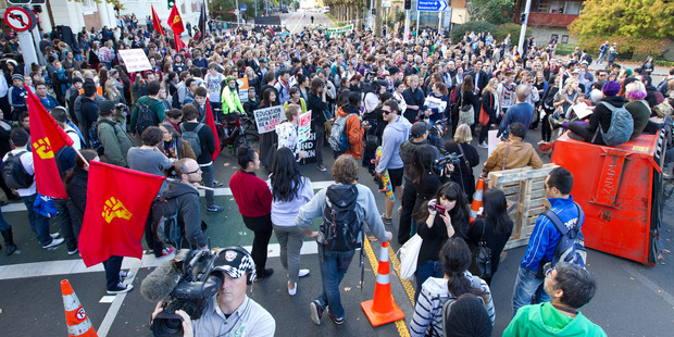 Auckland university students block traffic at the intersection of Symonds Street, Grafton Road and Alfred Street, during a student protest today. Photo / Steven McNicholl