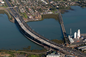 Emergency services received several calls about a dinghy capsizing near the old Mangere Bridge (pictured, right) shortly after 2pm this afternoon. Photo / Richard Robinson