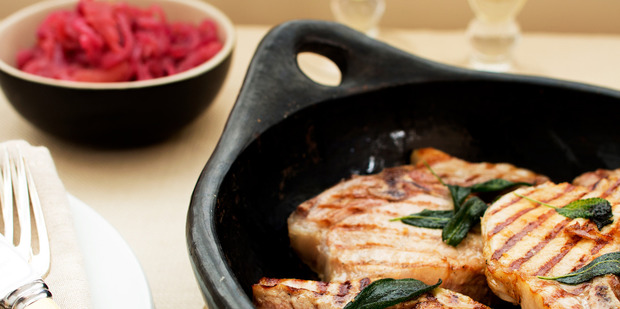 Stewed apples with red onions, grilled pork chops and sage butter. Photo / Babiche Martens