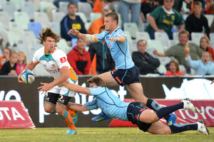 Riaan Smit of the Cheetahs tries to avoid the Waratahs' defenders. Photo / Getty Images