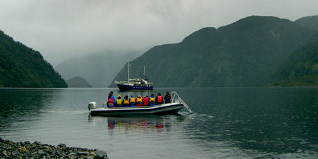 A runabout ferries passengers from the Milford Wanderer around the isolated inlets of Dusky Sound. Photo / Jim Eagles