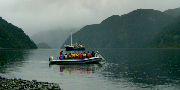A runabout ferries passengers from the Milford Wanderer around the isolated inlets of Dusky Sound. Photo / Jim Eagles