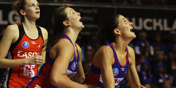 Anna Harrison of the Mystics is lifted up to defend a shot at goal by Jessica Moulds during the round nine ANZ Championship match. Photo / Getty Images.