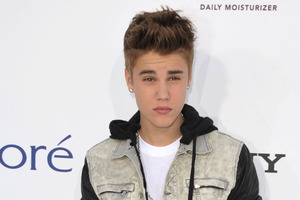 Justin Bieber suffered a concussion after walking into a glass wall, backstage of his Paris concert. Photo / AP