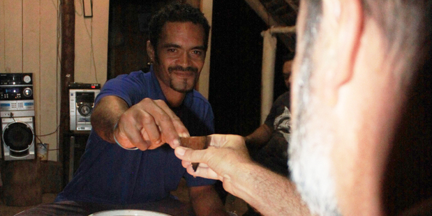 Drinking the special homebrew with the locals at a tumunu on Atiu island. Photo / Jim Eagles