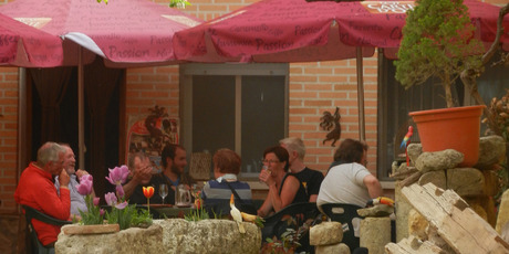 Pilgrims staying at the Boadilla del Camino albergue share a mid-afternoon drink. Photo / Simon Winter