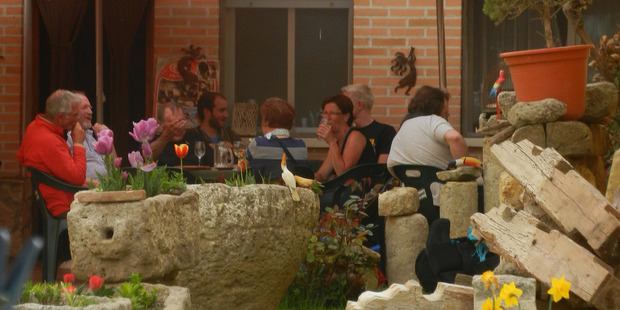 Pilgrims staying at the Boadilla del Camino albergue share a mid-afternoon drink. Photo / Simon Winter