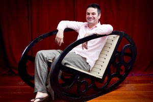 Justin Newcombe in his finished throne rocking chair. Photo / Natalie Slade