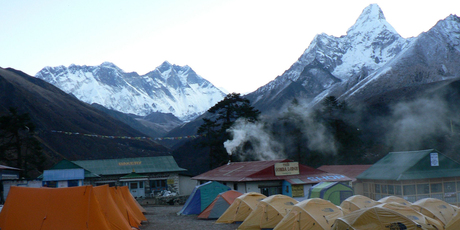 Early morning at the camp at Tengboche, with Mt Everest peering over the ridge at left. Photo / Jim Eagles
