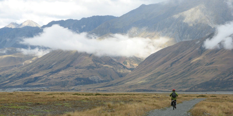 A cyclist heads towards Lake Pukaki in Mt Cook National Park on the Alps 2 Ocean Cycle Trail. Photo / John Parker