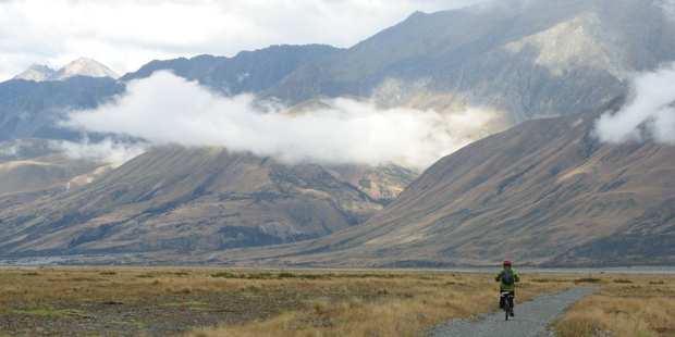 A cyclist heads towards Lake Pukaki in Mt Cook National Park on the Alps 2 Ocean Cycle Trail. Photo / John Parker