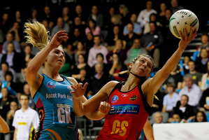 Irene van Dyk gets the ball under pressure from Storm Purvis. Photo / Christine Cornege