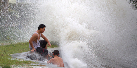 Hayden Karena and Caleb Warren brave the wild weather at Huia Beach in Auckland as an extreme high tide and a large swell combined with spectacular effect. Picture / Greg Bowker.