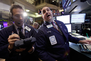 Trader Gregory Rowe, left, and specialist Peter Giacchi work on the floor of the New York Stock Exchange. File photo / AP