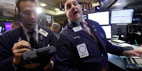 Trader Gregory Rowe, left, and specialist Peter Giacchi work on the floor of the New York Stock Exchange. File photo / AP