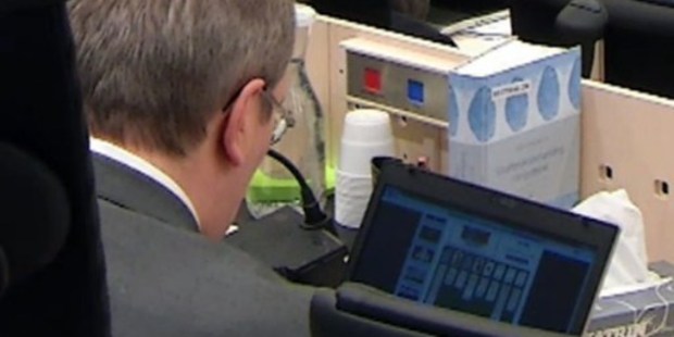 A photo grabbed on a video released by Norwegian televison NRK shows Ernts Henning Eielsen, one of the five judges in the trial against Anders Breivik playing solitaire online. Photo / AFP