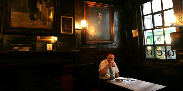 A patron sips his beer in the Ground Bar of Ye Olde Cheshire Cheese at 145 Fleet St. The Victorian London of Charles Dickens can still be seen, touched and smelled in places such as this. Photo / Bloomberg News