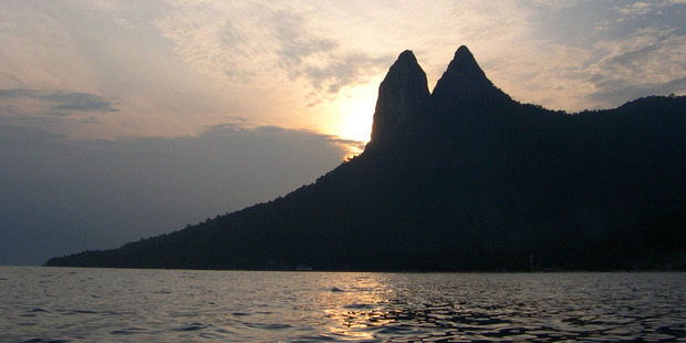 The sun sets behind the dragon's ears on Tioman Island, Malaysia. Photo / Jim Eagles