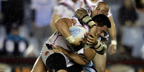 Konrad Hurrell of the Warriors is tackled by the Sharks defence during the round 15 NRL match between the Cronulla Sharks and the New Zealand Warriors. Photo / Getty Images.