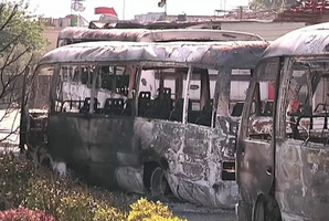 Buses burned in overnight fighting in Damascus. Photo / UN