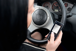 A woman who was texting while driving drove her car off a bank. Photo / Thinkstock