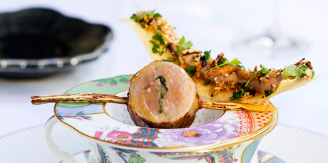 Quail and a wafer thin crisped potato strip spread with duck liver parfait balanced atop a floral tea cup. Photo / Babiche Martens