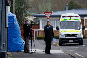 Investigators at the entrance to the driveway (rear) where 57-year-old Jordan Voudouris was found dead yesterday. Photo / Christine Cornege