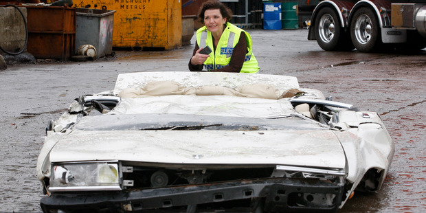 Police Minister Anne Tolley inspects the Nissan Laurel after it was crushed in Lower Hutt yesterday. Photo / Mark Mitchell