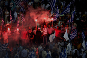 New Democracy party supporters at a final rally before elections today. Photo / Petros Giannakouris