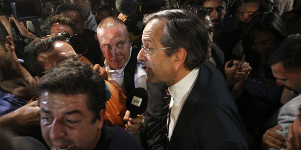 Leader of the New Democracy conservative party Antonis Samaras surrounded by media. Photo / AP