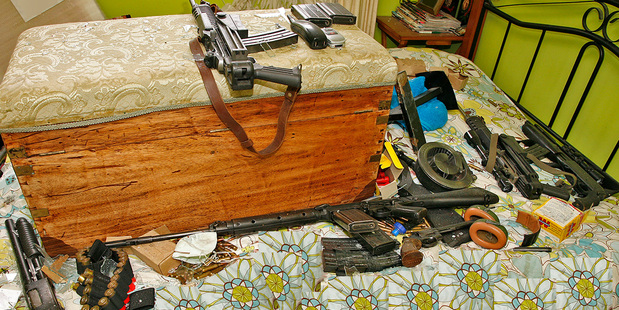 Firearms found in the bedroom (above) where Jan Molenaar shot himself at his Napier home, which was boarded up after the siege.