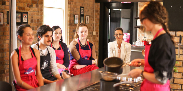 Julia Crownshaw teaches the Weekend Life competition winners expert tips and tricks at Auckland's Main Course Cooking School. Photo / Supplied