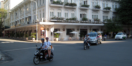 Motorcyclists pass in front of the Continental Hotel in Ho Chi Minh City, Vietnam. The city's colonial-era hotels are a colourful but comfortably up-scale alternative to global accommodation chains. Photo / Suree Pritchard
