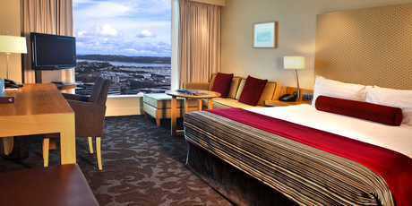 A hotel room at the Sky City Grand, with views out across Auckland. Photo / Supplied