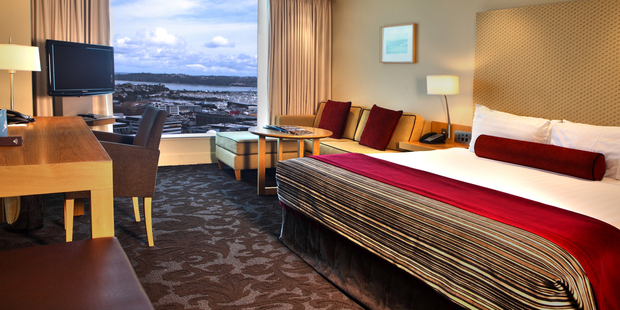 A hotel room at the Sky City Grand, with views out across Auckland. Photo / Supplied