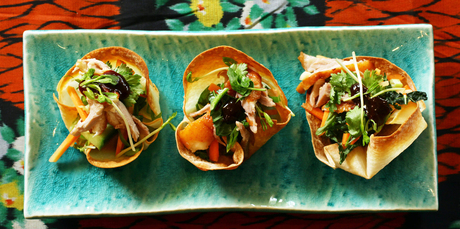 Shredded duck sits atop an Asian-inspired slaw nestled in wonton baskets. Photo / Janna Dixon
