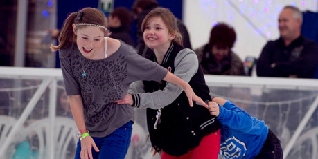 Friends muck around on the ice-skating rink in Aotea Square. Photo / Natalie Slade