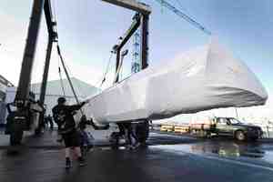One of the hulls of Emirates Team New Zealand's new catamaran arrives at their Auckland base. Photo / Richard Robinson