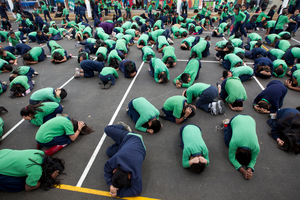Children from Mt Roskill and Mt Eden Primary Schools practise the 'drop, cover and hold' technique. Photo / Steven McNicholl