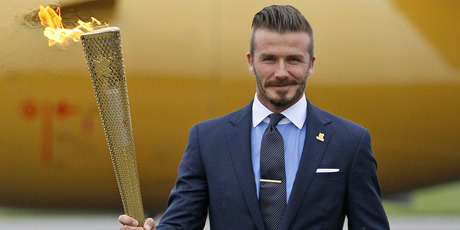 David Beckham with the Olympic torch. Photo / AP.