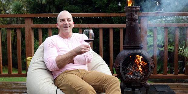 Cameron Douglas warms up with a glass of red and his treasured chiminea. Photo / Doug Sherring