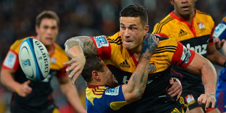 Chiefs second five-eighths Sonny Bill Williams offloads in his trademark style while held by Tamati Ellison in Dunedin last night. Picture / ODT