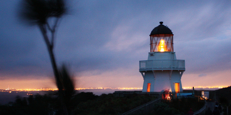 The Awhitu Peninsula lighthouse is lit by candles in a children's mid-winter light-up ceremony. Photo / Roger McCarry