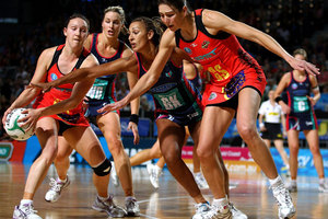 Khao Watts of the Magic grabs the ball ahead of Geva Mentor of the Vixens and Irene van Dyk of the Magic during the round four ANZ Championship match. Photo / Getty Images.