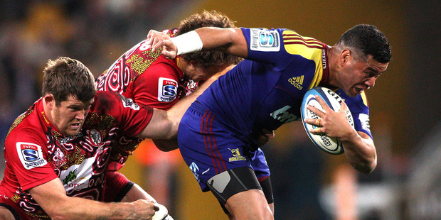 Siale Piutau of the Highlanders attempts to break free from the defence during the round 17 Super Rugby match between the Reds and the Highlanders. Photo / Getty Images.