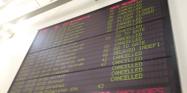 The departure board at Auckland Airport today showing cancelled flights due to the fog. Photo / Sarah Ivey