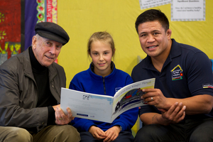 Winning story writer Holly Fisher, 10, with children's author John Parker (left) and All Black Keven Mealamu. Photo / Brett Phibbs