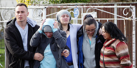 Grieving relatives leave the scene where Richard Tairua died after apparently trying to break up a fight. Photo / Doug Sherring