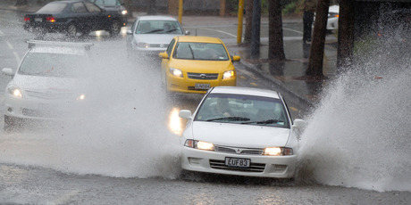 Motorists on the CBD's Mayoral Drive, got a free hubcap wash. Photo / Richard Robinson