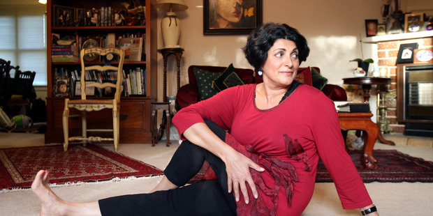 Dr Frances Pitsilis, a personal and corporate physician, relaxes at home with some yoga stretching. Photo / Janna Dixon